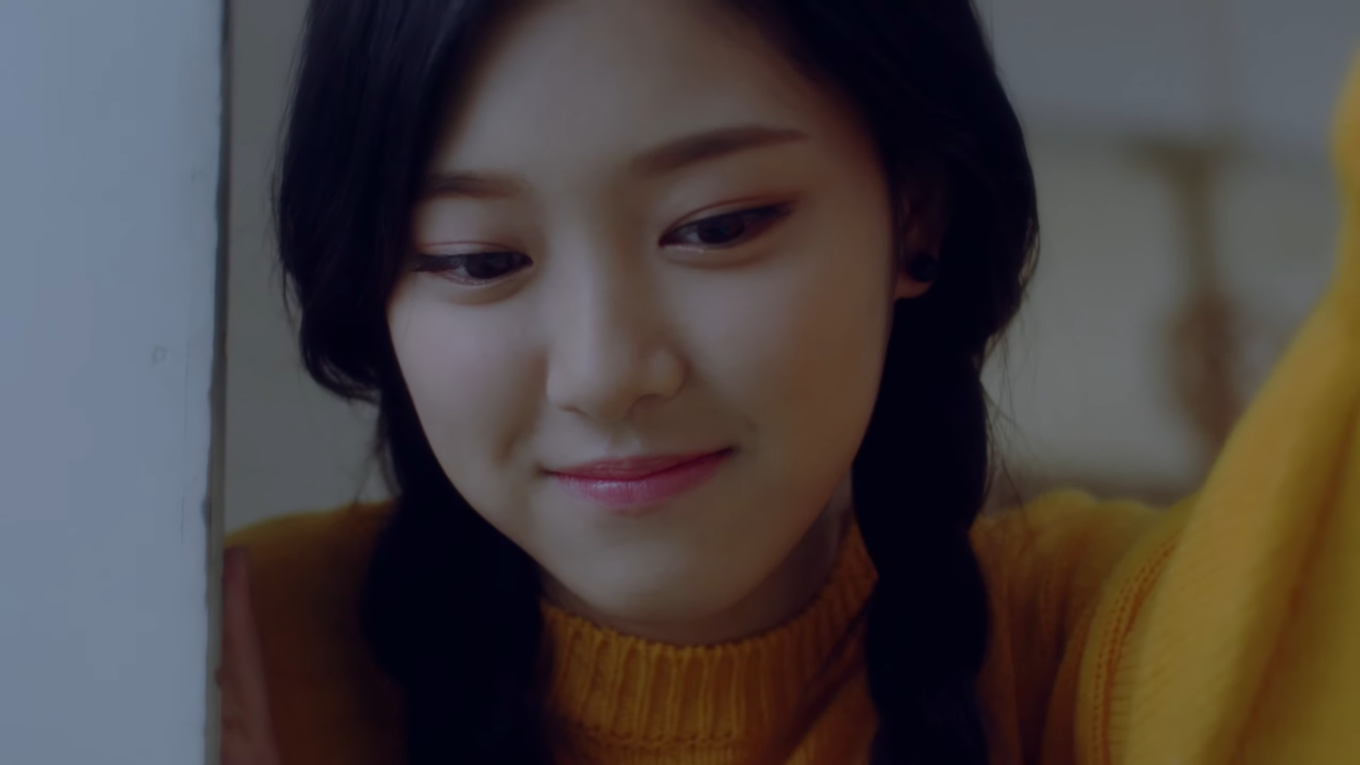 Hyunjin looking down and smiling.